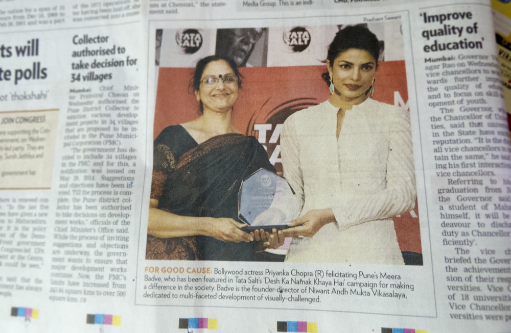 TechVision founder winning an award, stood next to Priyanka Chopra